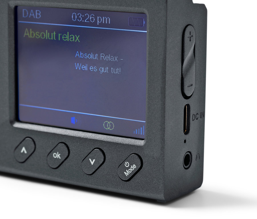 Detailansicht eines schwarzen, tragbaren DAB/FM-Radios mit Bluetooth, das "Absolut relax" auf dem Bildschirm anzeigt.