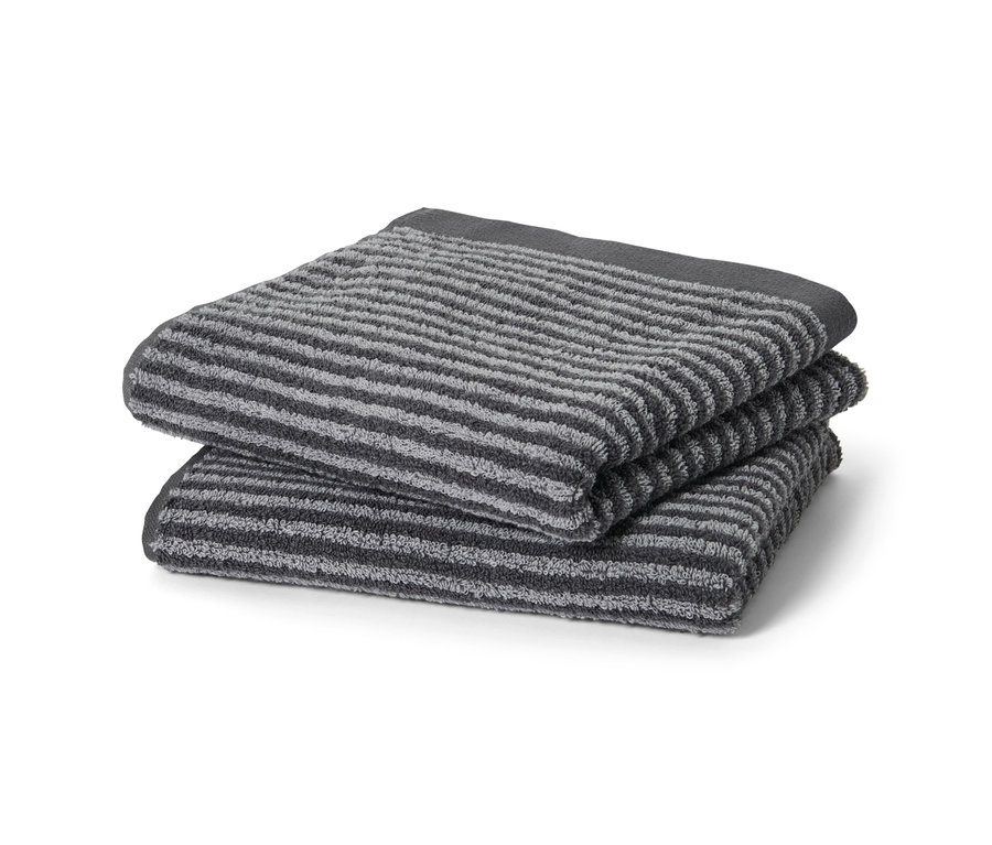 Zwei anthrazitfarbene, hochwertige Handtücher liegen gestapelt.