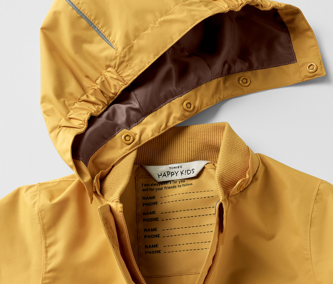 Detailaufnahme eines gelben Kinder-Regen-Einteilers mit Kapuze.