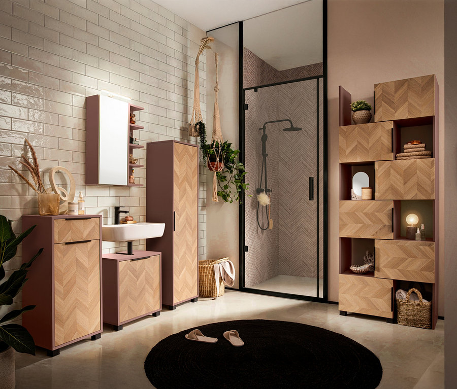 Badezimmer mit Waschbecken, Spiegel, Schrank und Dusche mit geometrischen Fliesen.