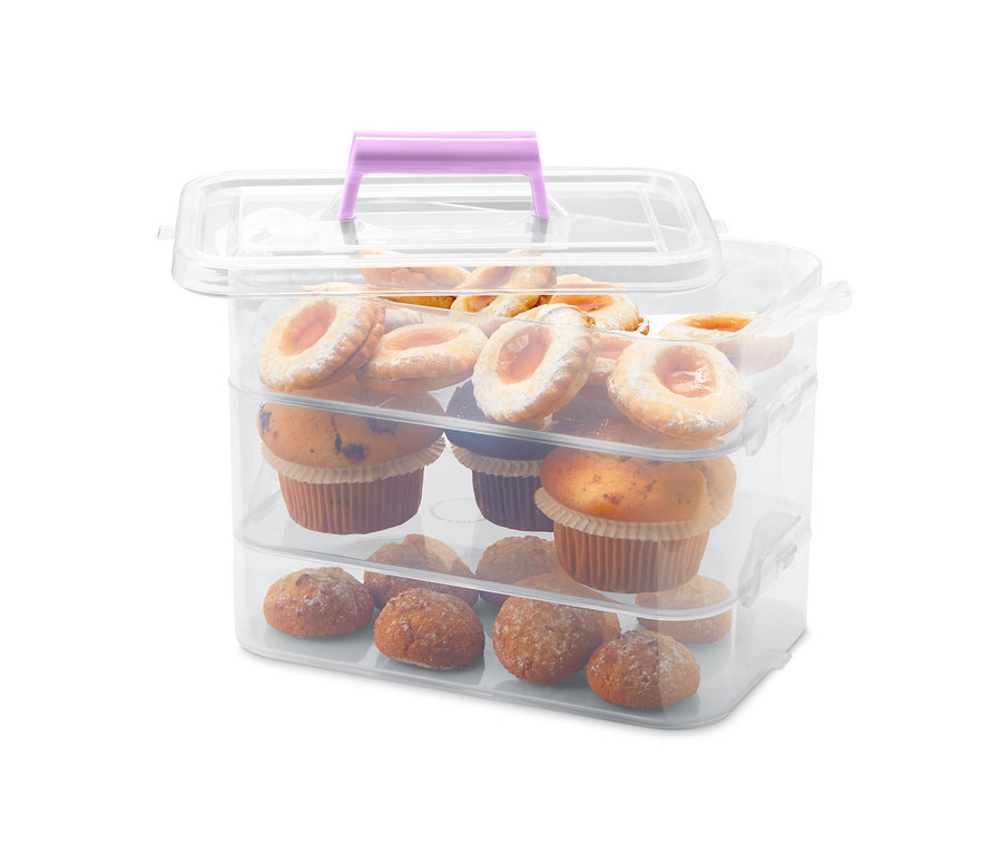 Dreistöckige Aufbewahrungsboxen mit lila Griff gefüllt mit Muffins und Keksen.