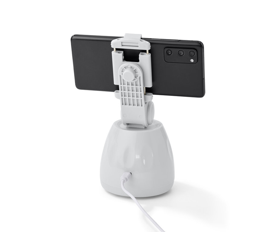 Ein schwarzes Mobiltelefon ist an einer weißen Handyhalterung mit Bewegungssensor befestigt.