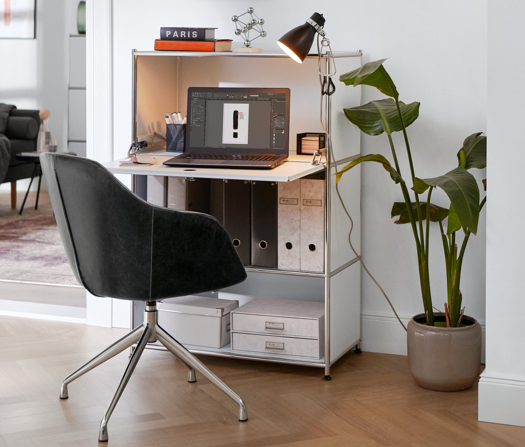 Gepolsterter Drehstuhl aus Kunstleder steht an einem weißen Sekretär Metall »CN3« mit Klemmleuchte.